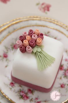 there is a small white cake with flowers on it