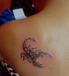 a woman with a scorpion tattoo on her back