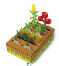 a cardboard box filled with plants and flowers