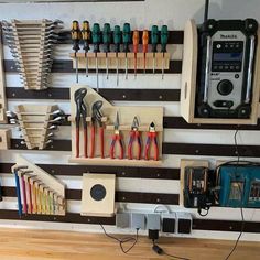 there are many tools hanging on the wall