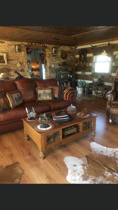 a living room filled with lots of furniture and decor on top of hard wood flooring