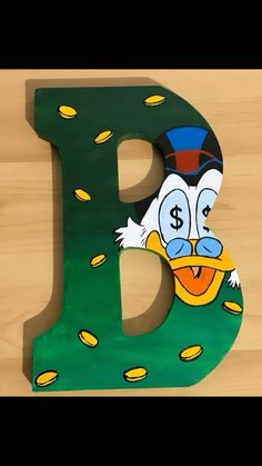 a wooden letter with a cartoon character on it's face and the letter d painted green