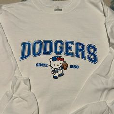 Dodger Kitty Sweater Brand New; Never Been Worn Size: Medium Unisex Color: White No Pattern/Design On The Back Dodger Sweater, Kitty Sweater, Sweater Brands, Colorful Sweaters, White Blue, Pattern Design, Blue White, Color White, Blue And White