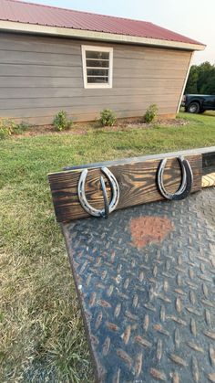 two horseshoes are mounted on the back of a truck bed in front of a house