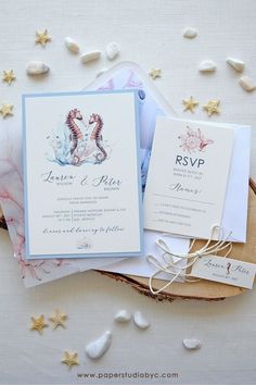 the wedding stationery is laid out on top of each other, including two cards