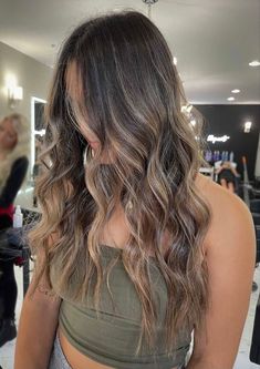 a woman with long, wavy hair in a salon