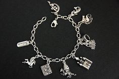 "A collection of silver plated fairy tale themed charms have been dispersed around a shimmering silver plated bracelet chain in this handmade charm bracelet. This fantasy storybook charm bracelet is then completed with a lobster clasp and a 1/2 inch of chain at the end for adjustable sizing. Charms in this bracelet include a \"Believe\" tab charm, pegasus charm, storybook charm, dragon charm, castle charm, princess charm with crown charm, unicorn charm, mermaid charm, and a fairy on the moon cha Adjustable Silver Jewelry For Fantasy Events, Whimsical Silver Charm Bracelet, Whimsical Silver Bracelet Jewelry, Whimsical Silver Dangling Charms, Fantasy Style Silver Bracelet, Adjustable Silver Fantasy Bracelet, Themed Charm Bracelet For Jewelry Making, Whimsical Nickel-free Silver Charm Bracelet, Whimsical Silver Charms For Gifts