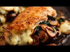 a close up of food on a plate with broccoli and mushrooms in it