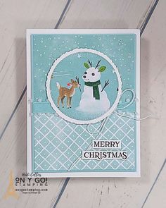 a christmas card with a snowman and deer