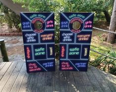 two signs are sitting on a wooden deck