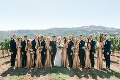 a group of people in formal wear posing for a photo