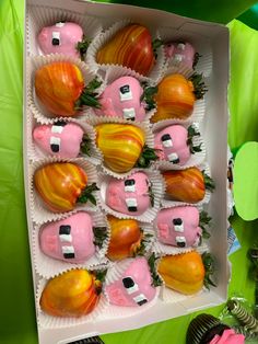 a box filled with lots of different types of food on top of a green table