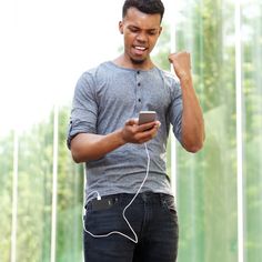 a man holding a smart phone and listening to music