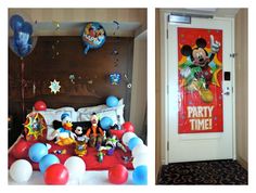 mickey mouse party time decorations and balloons in a room with a door to the bedroom