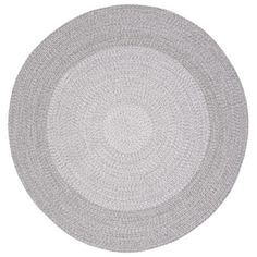 a round rug with white and gray circles on the bottom, in front of a white background