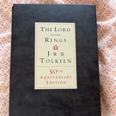 the lord of the rings j r r tolken 50th anniversary book on a bed