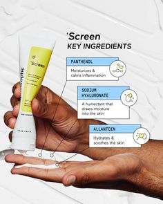 a hand holding a tube of sunscreen on top of a white surface with information about it