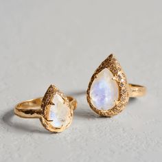 Mystic spell Ring- MoonstoneCaptivate your senses with the Mystic spell Ring, adorned with a pear-shaped rainbow Moonstone and a sparkling diamond aura. Materials Description:- 14K gold- 3.5ct Pear shape Moonstone.- 0.36ct vs diamonds.- Rough texture, High polish. - We are using only natural stones. Each stone is unique. Moonstone: "The Harmonizer"Both Romans and Greeks believed the Moonstone was delivered through rays from the moon due to its magical blue glow. The Moonstone is associated with Fine Jewelry Moonstone Teardrop Ring, Fine Jewelry Teardrop Moonstone Ring, Gold Teardrop Halo Ring, Pear-shaped Moonstone Gemstone Ring, Pear-shaped Gold Ring With Gemstone Accents, Gold Teardrop Rings With Gemstone Accents, Fine Jewelry Pear-shaped Moonstone Ring, Gold Teardrop Moonstone Ring For Wedding, Gold Teardrop Moonstone Wedding Ring