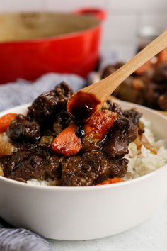 a white bowl filled with rice and meat