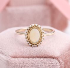 Vintage Opal Ring, Natural Australia Opal Halo Freshwater Pearl Ring, Rainbow Opal Anniversary Rings, October Birthstone, Opal Gemstone Ring ✧･ﾟ: *✧･ﾟ:* Welcome to Charles Davin Jewelry*:･ﾟ･ﾟ✧ ✶Material: 10K/ 14K/ 18K ✶Main Stone: Natural Australia Opal; 5*7mm ✶Side Stone: Natural Freshwater Pearls; 1.3mm (20 pcs) ✶Width of band: 1.7mm ✶Thickness of band: 1.2mm PRODUCTION TIME My team of jewelry artisans and I are ecstatic and cannot wait to share our passion, joy and creativity with you! Our je Heirloom Opal Ring With Gemstone Accents For Wedding, Oval Multi-stone Pearl Ring For Wedding, Opal Wedding Ring With Stone Setting, Wedding Opal Ring With Stone Setting, Senior Rings, Antique Opal Ring, Vintage Opal Ring, Opal Ring Vintage, Opal Wedding Rings