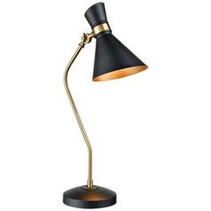 a black and gold desk lamp on a white background, with the light turned on