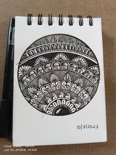 a black and white drawing of a bowl on a piece of paper next to a marker