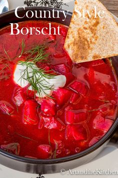 a bowl of soup with bread and sour cream on the side that says, country style borsch