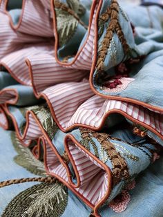 an up close view of some fabric with leaves on it and the edges folded down