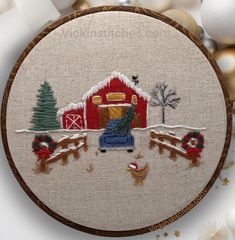 a cross stitch christmas ornament with a farm scene