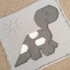 a crocheted rug with an image of a dog on it's back