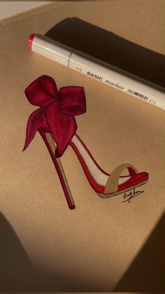 a drawing of a shoe with a red bow on it and a pencil next to it