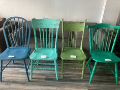 four different colored chairs sitting next to each other