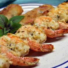 grilled shrimp on skewers with garnishes and mint sprig