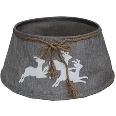 a gray and white lamp shade with reindeers on the side, tied in twine