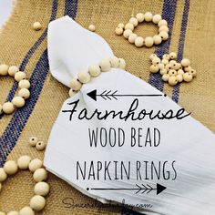 wood bead napkin rings are laid out on a burlap tablecloth with text overlay that reads farmhousee wood bead napkin rings