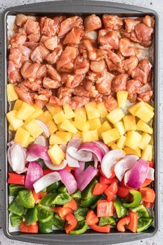 a tray filled with meat and vegetables on top of a table