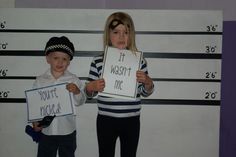 two young children holding signs in front of a police mugshot wall with the words, it was not me and you're rigged