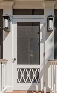 a white front door with two lights on each side and a window in the middle