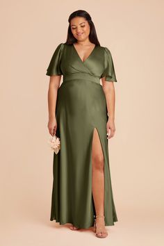 a woman wearing a green dress with a slited leg and high slits on the side