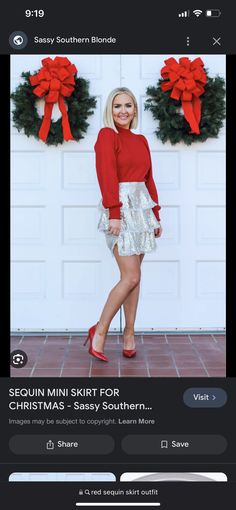 a woman in red shirt and white skirt standing next to a door with wreaths on it