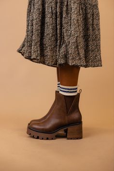 The Rusty is a dark brown bootie featuring a 3" heel and a small platform. Take inspo from our pictures and pair with your favorite boot socks and a floral dress! 3 1/4" heel; 1/2" platform 9 1/4" shaft; 10 1/2" calf circumference Contoured footbed Synthetic upper and lining/rubber sole *FINAL SALE* Floral Dress And Boots, Roper Boots Women's Outfit, Brown Boots With Chunky Platform And Round Toe, Fall Chunky Platform Ankle-high Wedge Boots, Brown Platform Ankle Heeled Boots, Brown Chunky Platform Heeled Boots For Winter, Brown Ankle-high Wedge Boots For Winter, Brown Platform Boots With Medium Width And Round Toe, Winter Brown Chunky Platform Heeled Boots