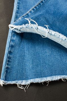 an old pair of blue jeans with torn edges