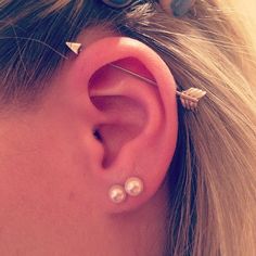 a close up of a person's ear with two small studs on it