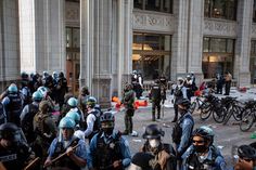 police officers and protesters in front of a building