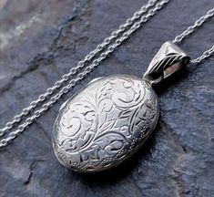 ♥ Welcome to RAVEN FALLS ♥ Celtic, Curios, Cats, Trees & Crows  ✯ VINTAGE LOCKET NECKLACE ✯ ✯ STERLING SILVER ✯ This is a pretty silver locket necklace.  It is a puffy oval shape with a delicate engraved pattern on the front and the back.  Inside there are royal blue velvet inserts and it is marked for sterling silver on the inner rim with 925.   It comes suspended on an 18" sterling silver chain.  Please see photos for more details, thanks.  SPECIFICS Approx Measurements and weight: Pendant loc Vintage Locket Necklace, Sterling Silver Locket Necklace, Locket Necklace Vintage, Silver Locket Necklace, Vintage Locket, Silver Locket, Vintage Lockets, Silver Lockets, Locket Necklace