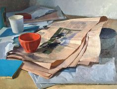 a pile of newspapers sitting on top of a table next to a cup and saucer