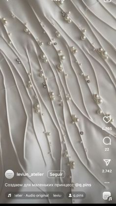 an image of pearls on white fabric