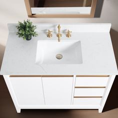 a white sink sitting under a mirror on top of a counter