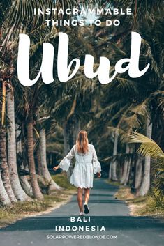 a woman walking down the road in front of palm trees with text that reads instagramable things to do aloud bali indonesia