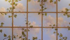 an artistic photo of leaves and clouds in the sky on a glass paneled wall